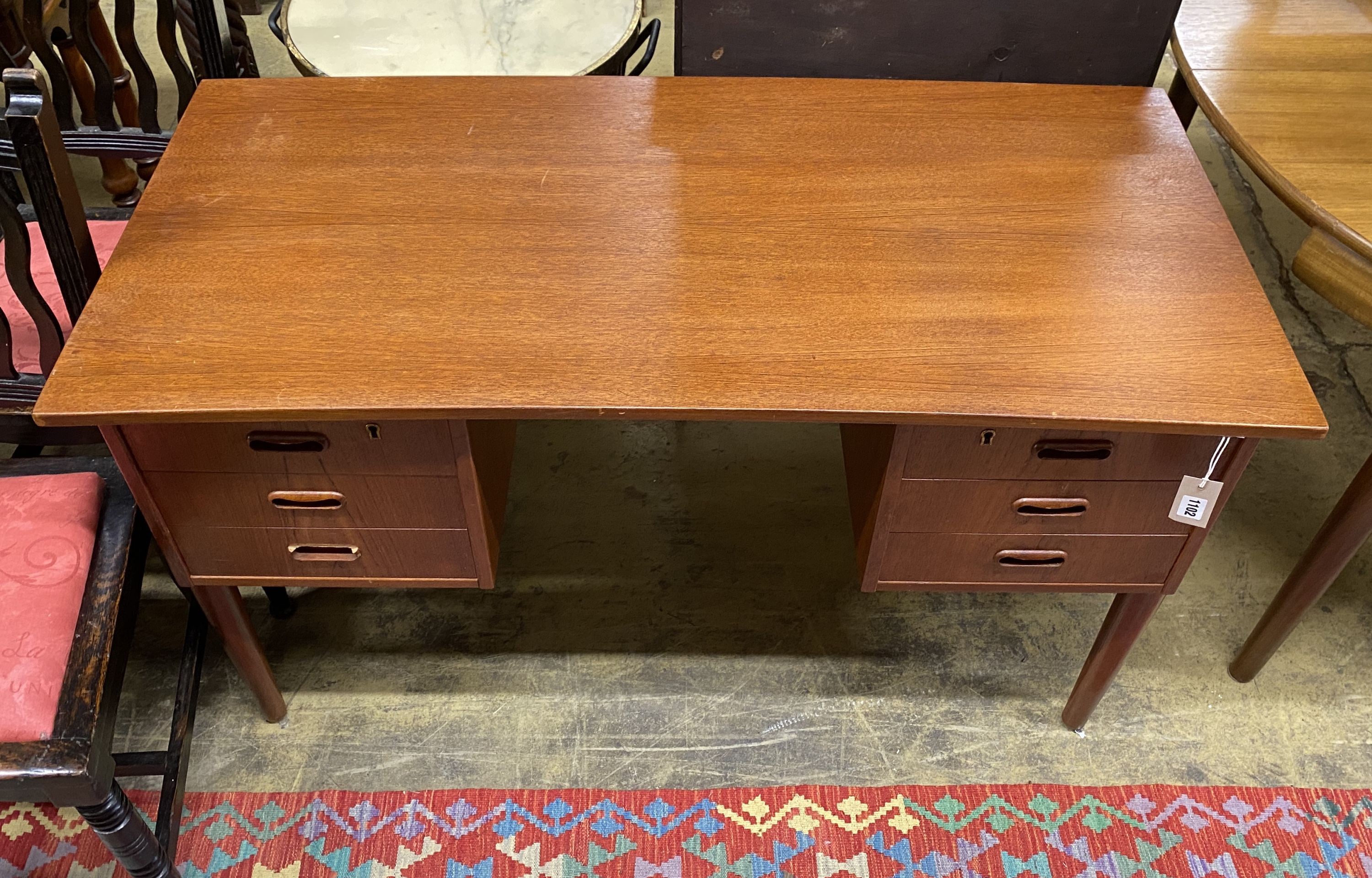 A mid century Danish teak kneehole dressing table of rectangular concave form, width 116cm, depth 55cm, height 72cm